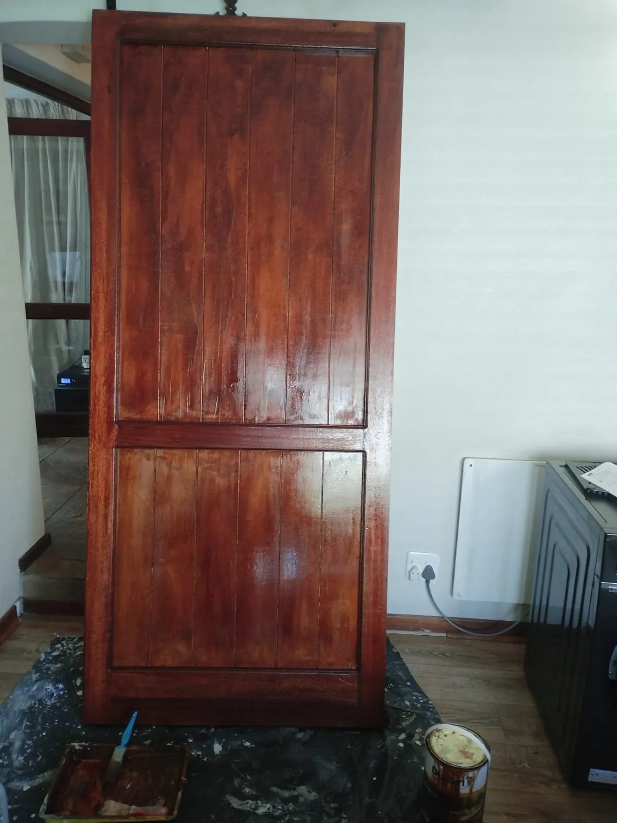 The finished barn door with all panels stained an even deep red-brown
